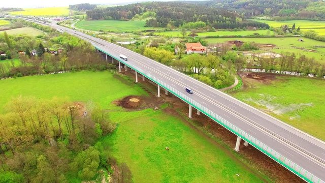 Aerial view of bridge over Radbuza River and green pastures. Highway D5 with traffic near Pilsen, Czech republic, Central Europe. Transportation and sustainable development concept. 