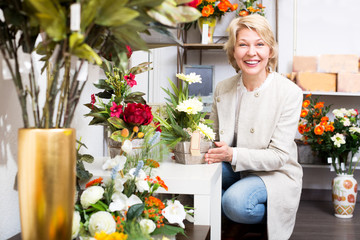 Woman smiling among multicolored flowers