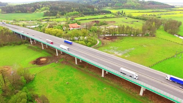 Aerial view of bridge over Radbuza River and green pastures. Highway D5 with traffic near Pilsen, Czech republic, Central Europe. Transportation and sustainable development concept. 