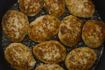 Homemade cutlets background in boiling oil
