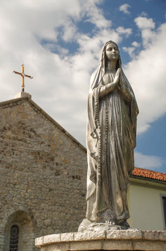 Virgin Mary Statue against a blue sky. The church of Our Lady of Annunciation. Lezhe / Albania