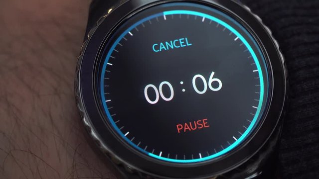 Closeup of a smart watch on male hand. The man turns on the timer. A countdown of 10 seconds before the end of time