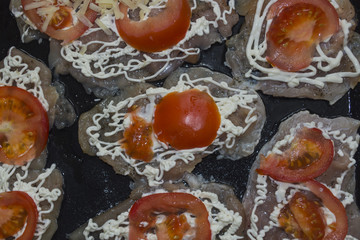 Tomato segments laid on  chicken fillet