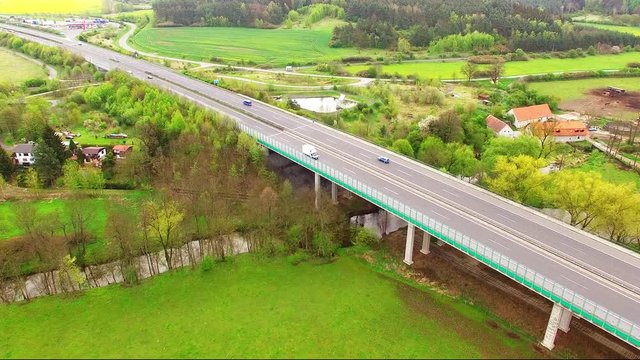 Aerial view of bridge over Radbuza River and green pastures. Highway D5 with traffic near Pilsen, Czech republic, Central Europe. Transportation and sustainable development concept. 