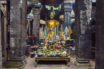 Buddha statue inside the sanctuary in Vat Phou (or Wat Phu) - Khmer Hindu temple complex in Champasak Province, southern Laos