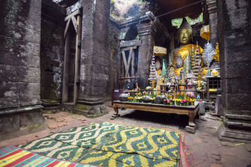 Fototapeta premium Buddha statue inside the sanctuary in Vat Phou (or Wat Phu) - Khmer Hindu temple complex in Champasak Province, southern Laos