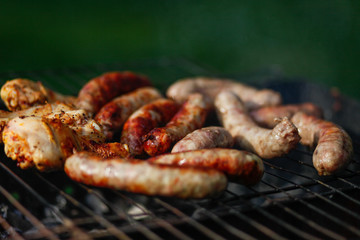 Cook out. Sausages and chicken on grill