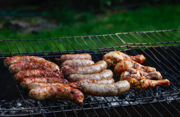 Cook out. Sausages and chicken on grill