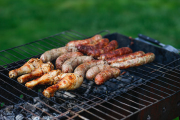 Cook out. Sausages and chicken on grill