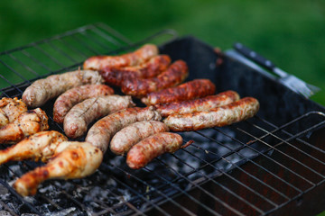 Cook out. Sausages and chicken on grill