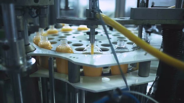 Packaging machine / process of packaging liquid soap in a modern factory / Line of packaging at a cosmetic plant / Plastic containers on a packaging line at a cosmetic factory / Industrial equipment