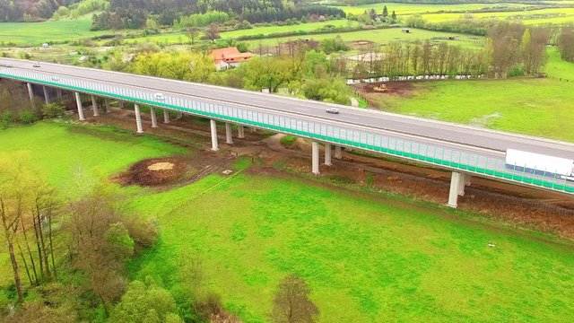 Aerial view of bridge over Radbuza River and green pastures. Highway D5 with traffic near Pilsen, Czech republic, Central Europe. Transportation and sustainable development concept. 