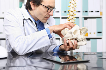 Crazy doctor with skull in office, insane concept