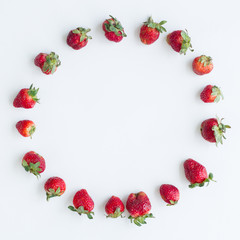 Oval frame of strawberries on white background. Flat lay, top view. Size 1x1