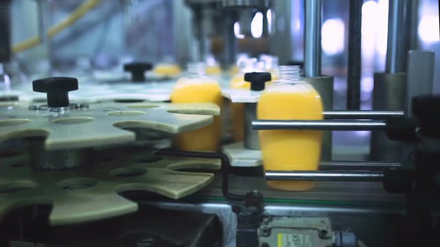 Packaging machine / process of packaging liquid soap in a modern factory / Line of packaging at a cosmetic plant / Plastic containers on a packaging line at a cosmetic factory / Industrial equipment