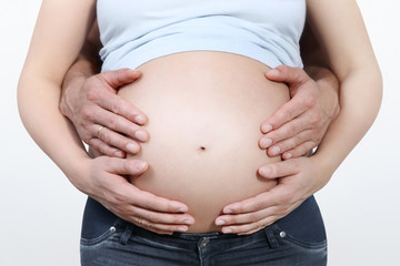 couple hands on the pregnant  belly, concept of pregnancy, expecting a baby, love, care
