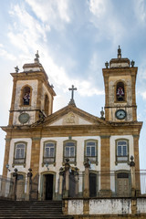 Fototapeta na wymiar Street view of Sao Joao del Rei with Nossa Senhora do Carmo Church on backgound - Sao Joao Del Rei, Minas Gerais, Brazil