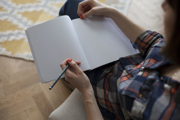 Woman with Manicured Nails and Plaid Shirt Drawing in Blank Notebook Retro