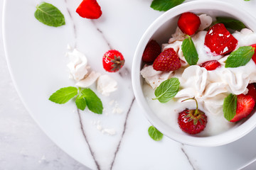 Eton Mess - Strawberries with whipped cream and meringue  Classic British summer dessert.selective focus