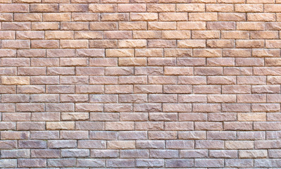 Background of yellow facing bricks. Bricks relief close up.