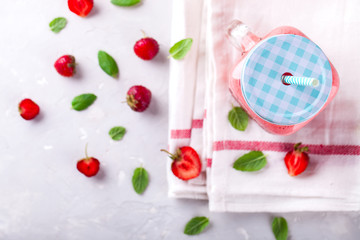 Strawberry smoothie or milkshake in jar with fresh mint.Healthy food for breakfast and snack.Super Food.Copy space for Text. selective focus.