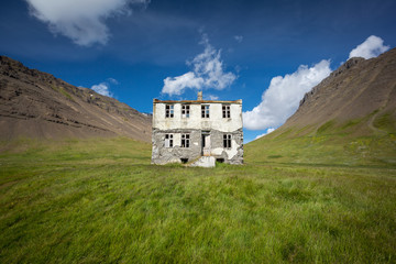 Exterior view of abandoned house on grassy field