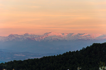Idyllic panorama view of Sierra Nevada during sunset in March, captured in Moclín, Andalusia, Spain