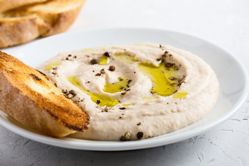 White bean dip on white plate