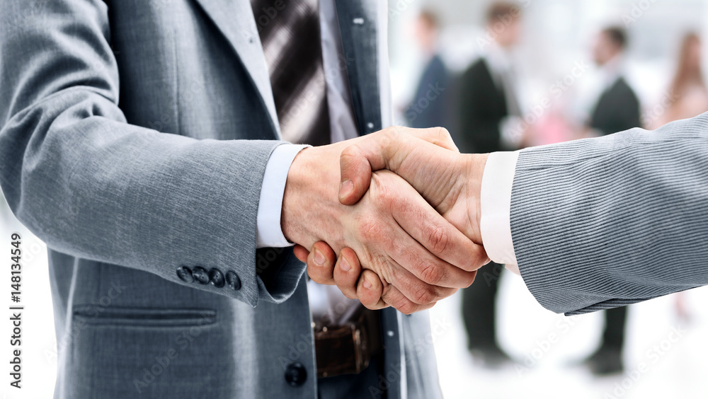 Wall mural businessman shaking hands to seal a deal with his partner