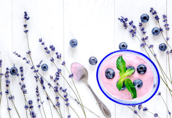 lavender flowers with blueberry yoghurt mock up on white background top view