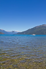 Boat at the lake side with mountain range in the background close to El Bolsón. Perfect place for...