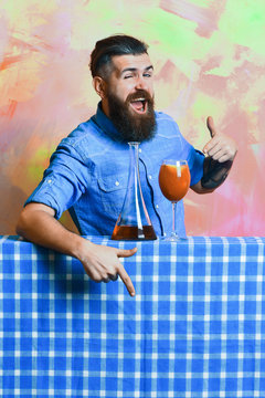 Brutal caucasian hipster with alcohol cocktail and flask