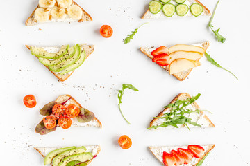 homemade sandwiches composition on white table background top view