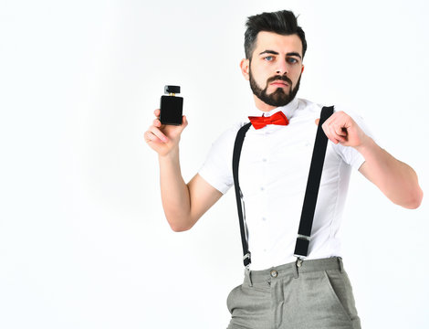 Bearded man, caucasian hipster with moustache and perfume bottle
