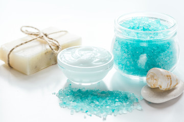 Obraz na płótnie Canvas spa composition with blue sea salt and natural soap on white desk background