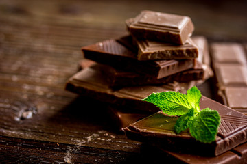 black and milk chocolate bars dark wooden table background