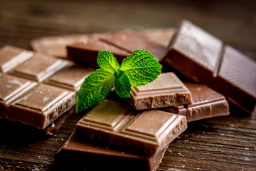 black and milk chocolate bars dark wooden table background