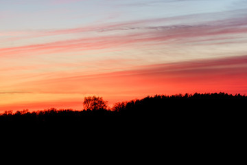 sunset over a hill top - silhouette