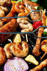 Assorted types of meat and vegetables on the grill