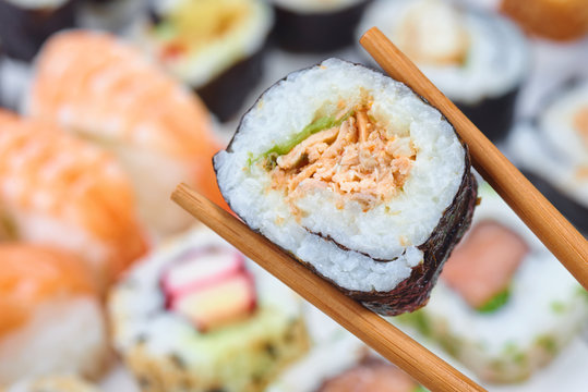 Sushi set. Chopsticks with portion of sushi