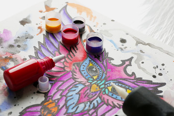 Tattoo sketch and supplies on table