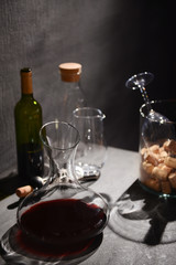 Glass carafe of wine on table against gray background