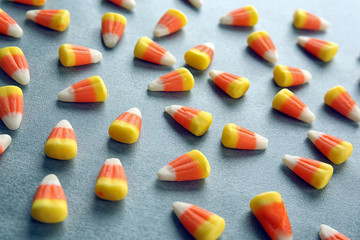 Tasty Halloween candies on light background