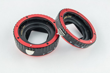 Set of macro rings for SLR cameras on a white background.
