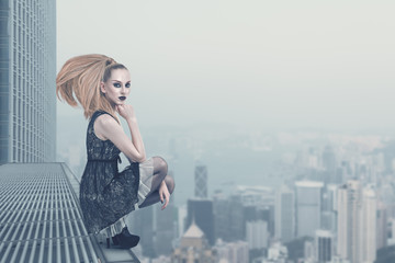 Fototapeta na wymiar Sad fashion model on the rooftop