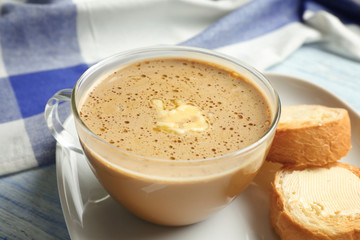 Composition with tasty butter coffee on wooden table, closeup