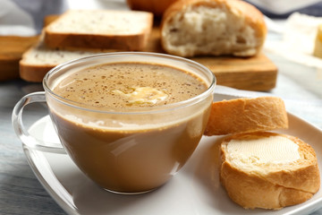 Composition with tasty butter coffee on wooden table, closeup