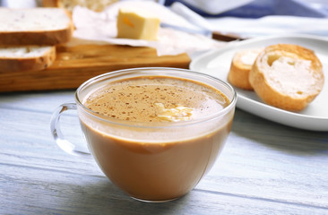 Cup of tasty butter coffee on wooden table