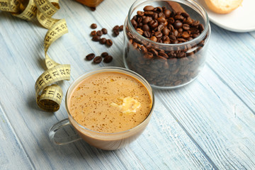 Composition with tasty butter coffee on wooden table