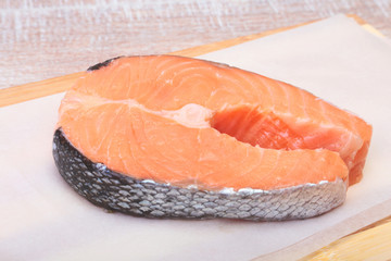 fresh raw salmon with spices on wooden cutting board. ready for cookin